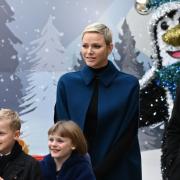 La Principessa Charlene sorridente distribuisce i doni di Natale