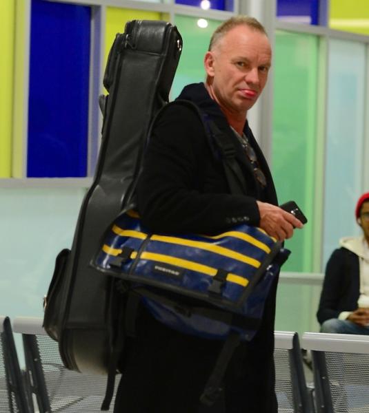 Sting sticks his tongue out as he departs JFK Airport