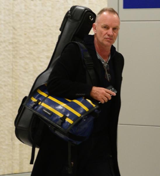 Sting sticks his tongue out as he departs JFK Airport