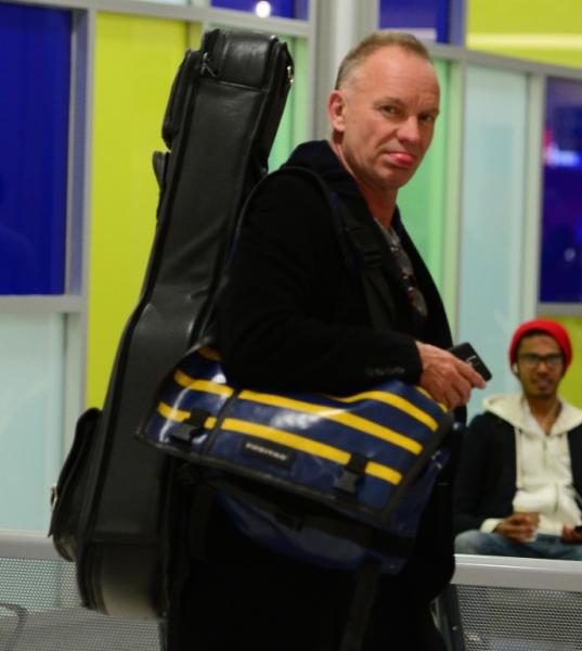 Sting sticks his tongue out as he departs JFK Airport